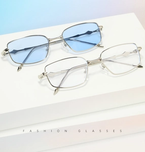 Detail of geometric metal sunglasses with wavy temples and light blue lenses