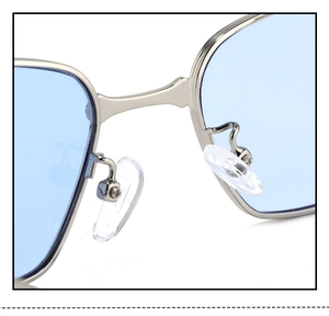 Detailed macro view of silver metal nose bridge and adjustable clear pads on sunglasses