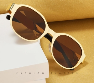 Detail of vintage gold thick metal frame sunglasses with brown lenses on white blocks