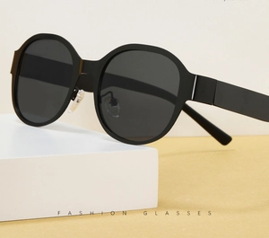 Detailed view of oversized black sunglasses with dark lenses and clear nose pads