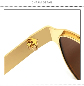 Detailed close-up showing the golden metal hinge and screws of these vintage sunglasses