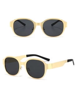 Detail of oversized gold metal sunglasses with dark lenses and adjustable nose pads