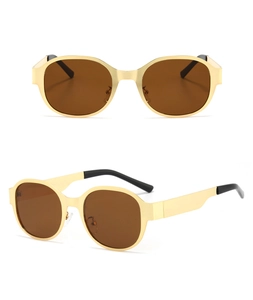Detail showing vintage gold metal square sunglasses frames with brown lenses and black temple tips