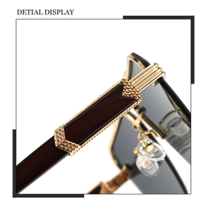 Detail of dark wood grain temples with gold metal accents and premium textured finish