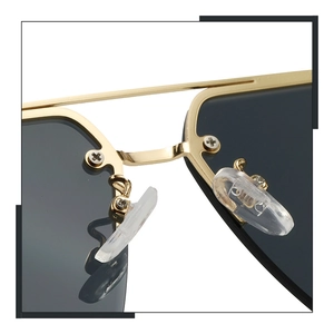 Detail of gold metal frame sunglasses with anti-slip silicone nose pads and dark lenses