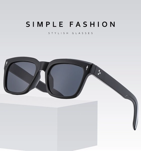 Close-up of square sunglasses frame with silver metal arrow and star details