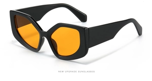 Side view of geometric polygonal sunglasses with black frame and orange lenses