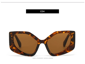 Detail view of oversized polygonal sunglasses in tortoise shell frame with brown lenses