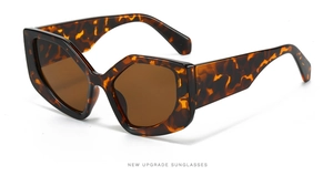 Macro detail of tortoiseshell polygon sunglasses frame with brown tinted lenses
