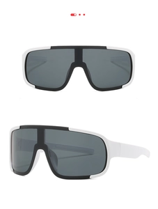 Detail of black and white sport goggles with dark grey oversized protective lenses
