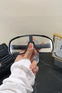 Detail view of CY5567 oversized black sports glasses held to show the lightweight frame