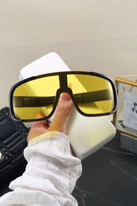 Detailed shot of yellow lens sports glasses with CY5567 model code on the inner temple