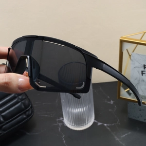 Detail view of matte black sports sunglasses with a large integrated grey lens and frame