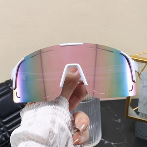 Close-up of lightweight white cycling sunglasses with pink to green gradient lenses