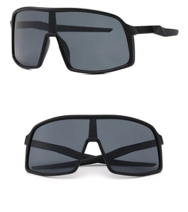 Close-up of matte black sports sunglasses with wide grey panoramic anti-wind lenses
