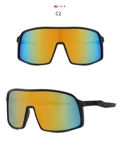 Close-up of matte black cycling sunglasses with orange-cyan gradient mirror lens