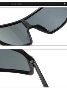 Detail view of the black sports sunglasses featuring integrated lenses and durable metal hinges