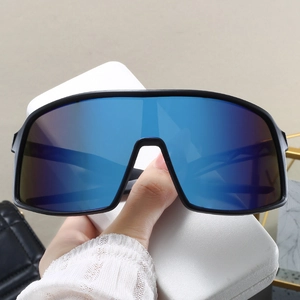 Detail of oversized sports sunglasses with blue mirrored lenses and black frame
