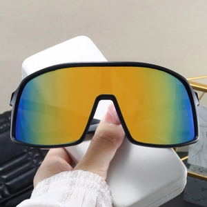 Macro view of matte black sports sunglasses with colorful gradient lenses and white case