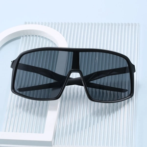 Modern oversized wrap-around sunglasses with matte black frame and dark grey lenses for sports