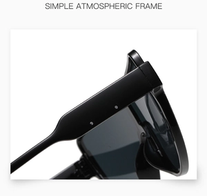 Macro delle stanghette ampie su occhiali da sole neri lucidi oversize con linee fluide