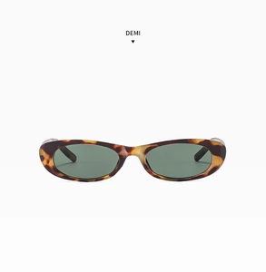 Detailed front view of oval tortoiseshell sunglasses with dark lenses on white background