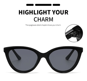 Detail view of black cat-eye sunglasses with grey lenses and hinge mechanism