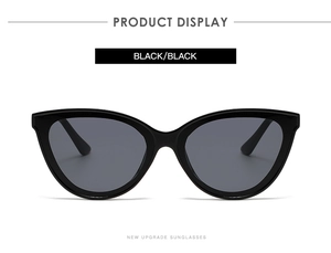 Close-up of classic black cat-eye sunglasses with dark lenses and glossy finish