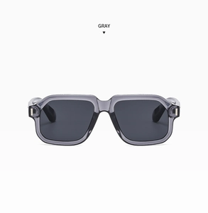 Detailed front view of gray translucent square sunglasses with silver metal hinges