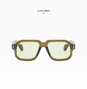 Detail view of olive green retro square frames with light yellow-green tinted lenses