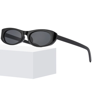 Retro oval sunglasses with black glossy frames and gray lenses on white pedestal