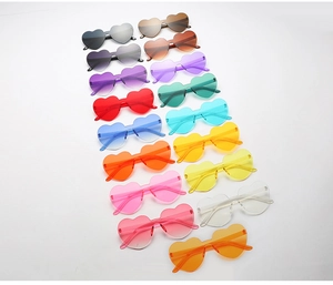 Close-up of frameless heart-shaped sunglasses in vibrant candy colors and gradient lenses