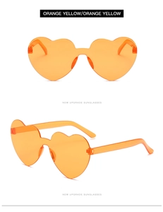 Detail view of heart shaped rimless sunglasses in bright orange yellow candy color