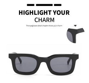 Détail de lunettes de soleil carrées noires avec loupe montrant la finition lisse