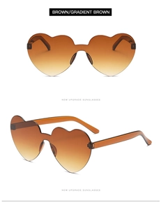 Close-up of rimless heart sunglasses with brown gradient lenses and transparent temples
