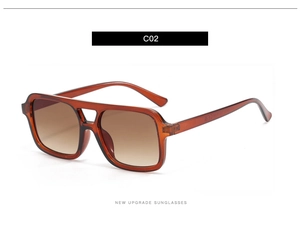 Detailed side view of amber tortoiseshell sunglasses with double bridge and gradient lenses