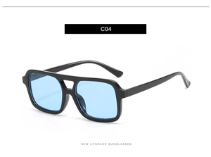 Detail of retro pilot sunglasses with thick black frame and light blue gradient lenses