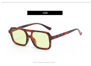 Detail of tortoise frame sunglasses with yellow lenses and double bridge design