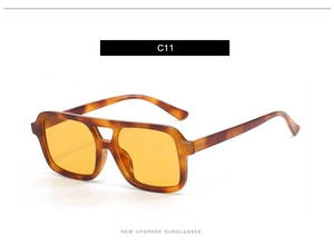 Detail of tortoise shell frame sunglasses with yellow lenses and double bridge bar design