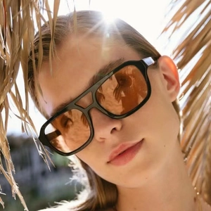 Retro oversized square sunglasses with black frames and orange tinted lenses for summer