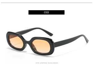 Detailansicht der ovalen schwarzen Sonnenbrille mit kräftig orangefarbenen Gläsern