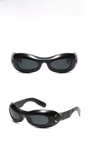 Detail view of black chunky sunglasses with metallic rivet cannage pattern on temples