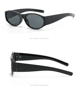 Détail de lunettes de soleil ovales rétro avec branches larges et monture noire
