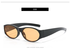 Vue détaillée de lunettes de soleil ovales avec monture noire brillante et verres orange vif