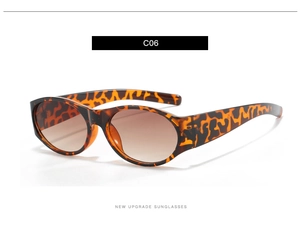Détail des lunettes de soleil ovales en écaille C06 avec verres dégradés marron