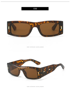 Détails de lunettes de soleil rectangulaires écaillées avec accents dorés et verres marron