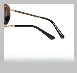 Detail of curved golden metal temples with black tips for comfortable sunglass wear
