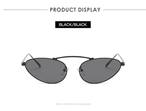 Detail view of oval punk sunglasses featuring black metal frames and dark lenses