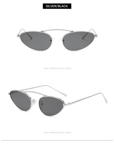 Detail of silver oval punk sunglasses with black lenses and metal double bridge frame