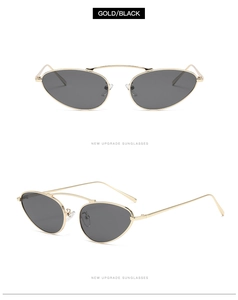 Macro detail of gold metal frame and black lenses on oval punk style sunglasses